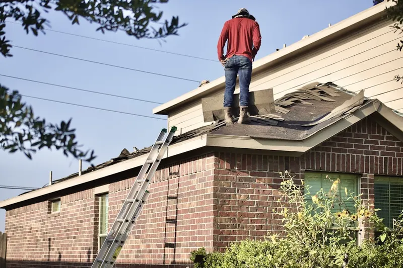 Professional roofer working on a residential roof in Cherry Creek